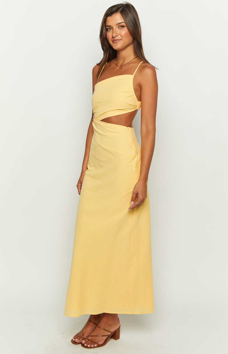 Side view of the yellow textured maxi dress with a square neckline, side cutouts, and a flowing maxi skirt