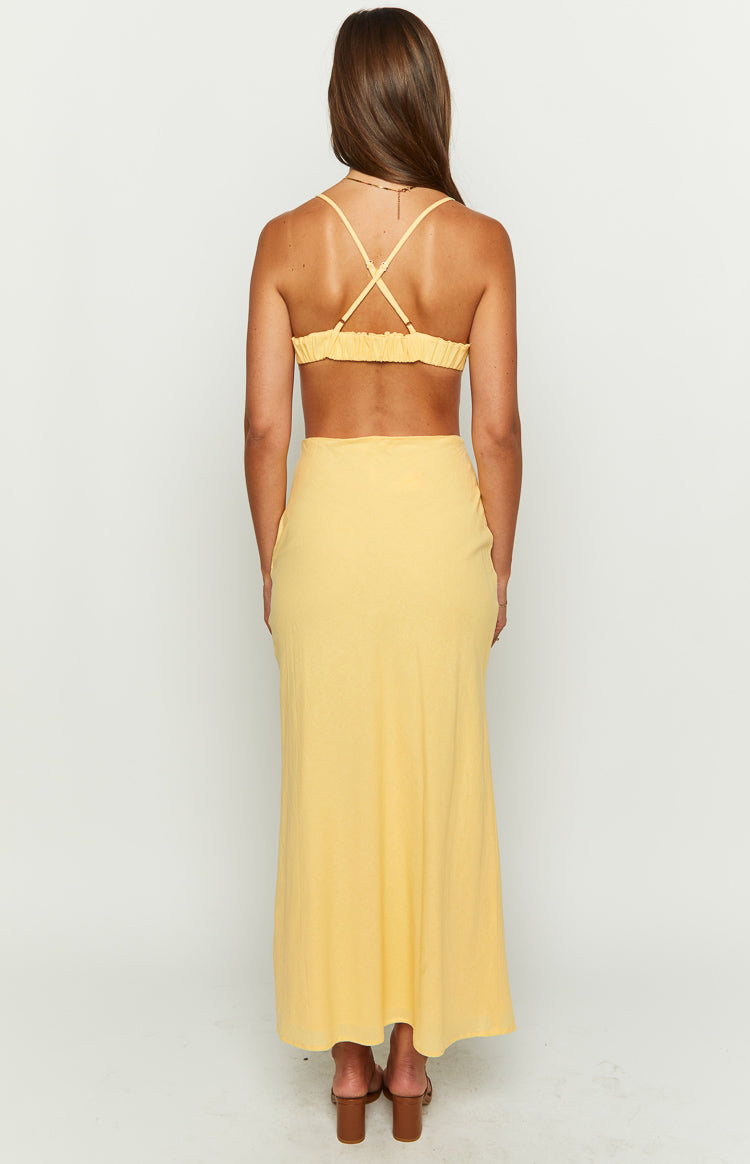 Yellow maxi dress rear view with criss-cross spaghetti straps, ruched elastic back, and cut-out waist