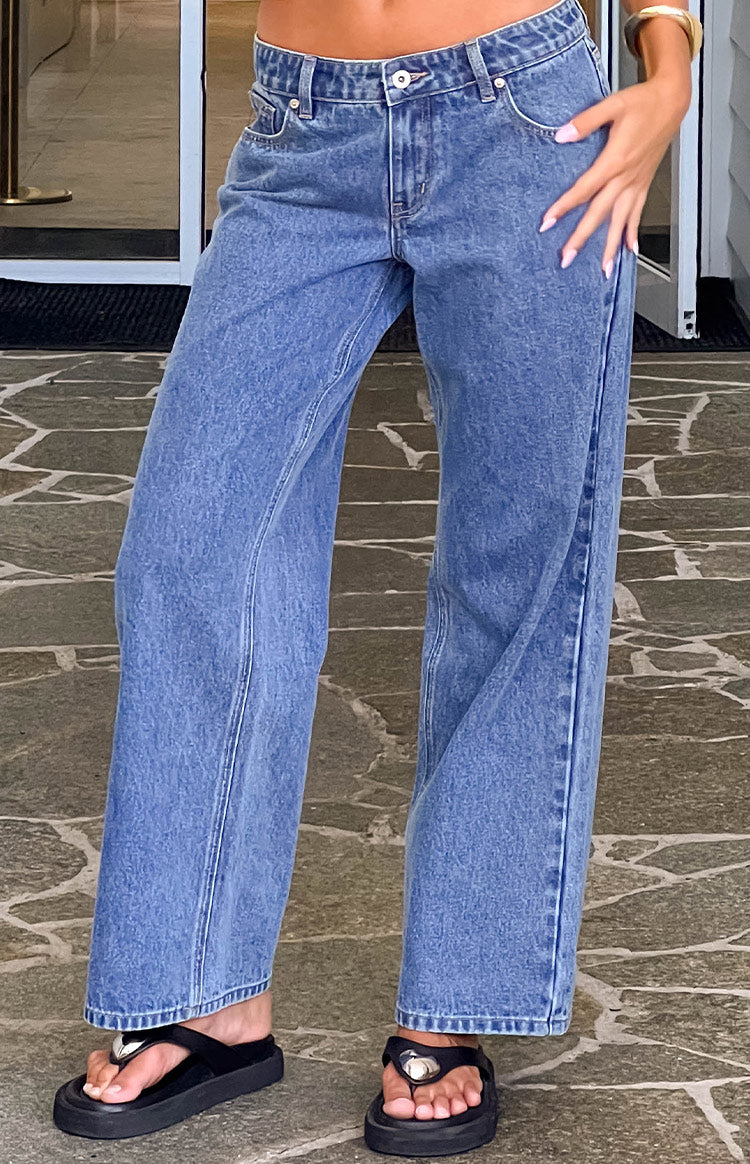 Mid-wash denim low-rise jeans with wide legs and visible side seams