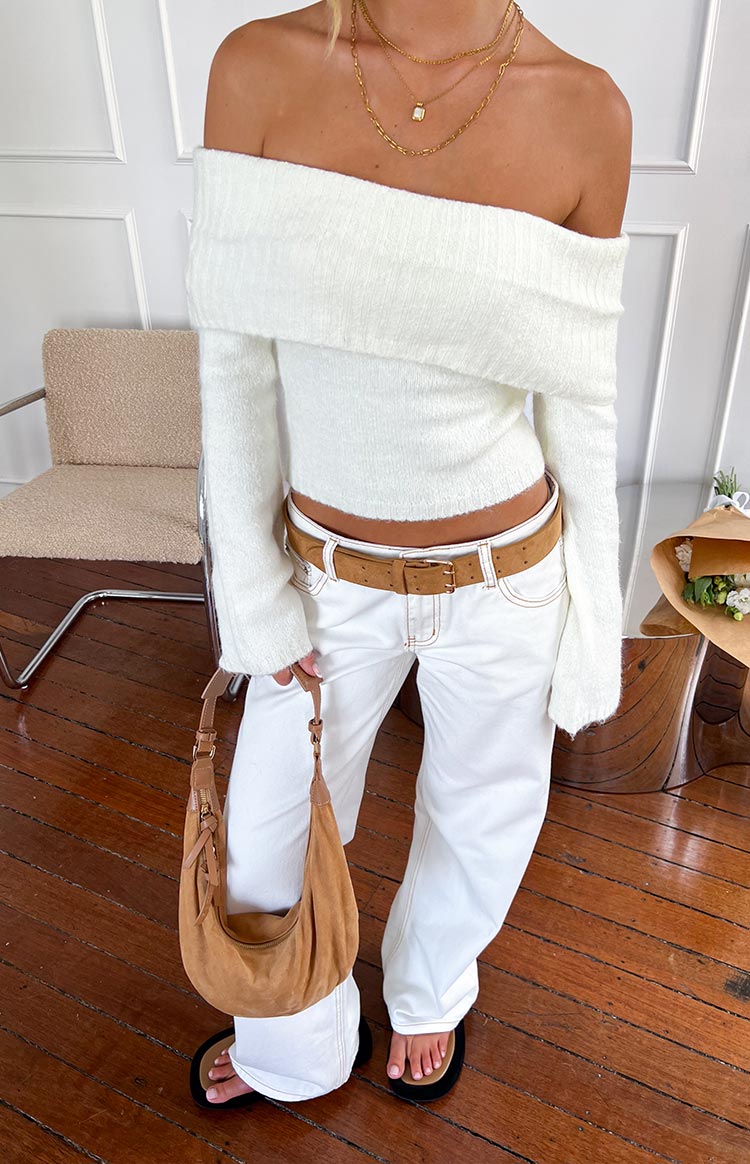 Full length view of white low-rise denim jeans with a relaxed wide-leg and contrasting tan stitching