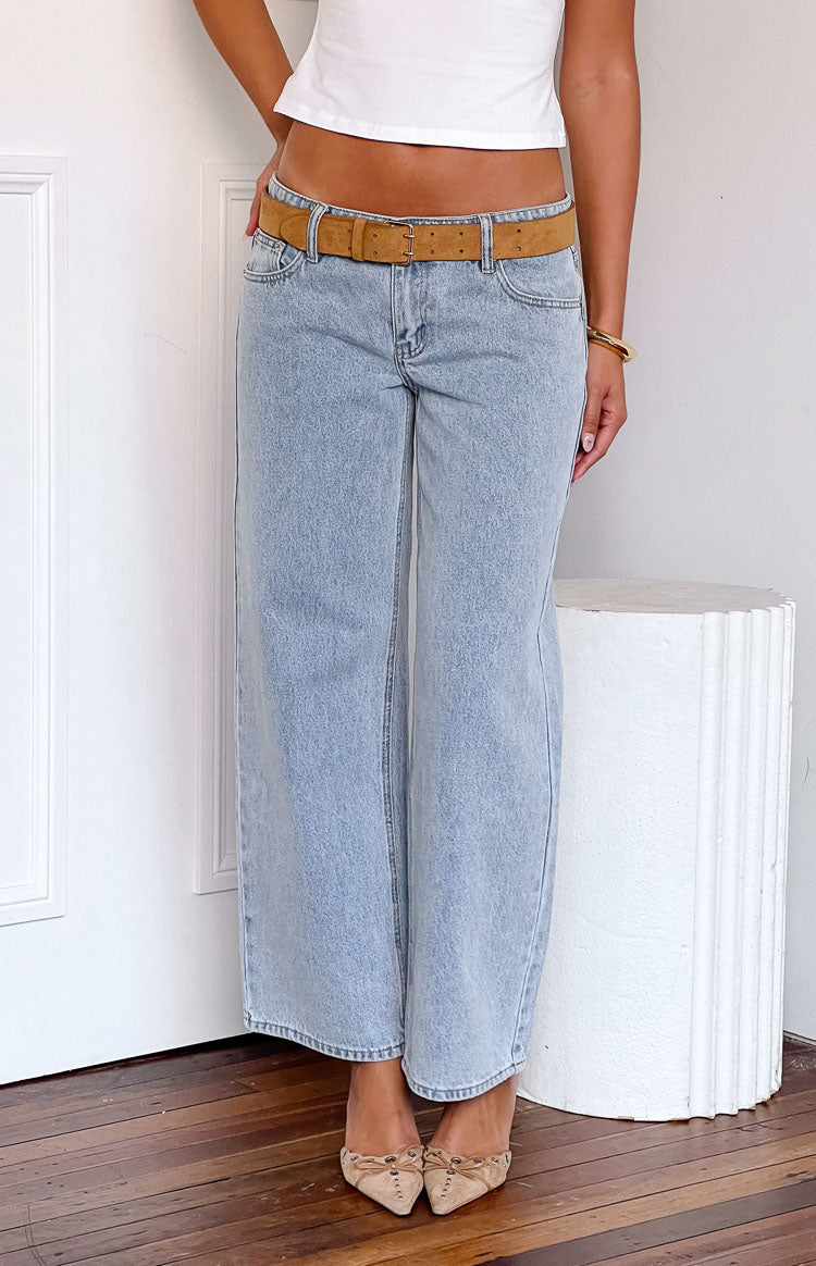 Front view of light wash denim low rise jeans with a relaxed wide leg and distressed texture