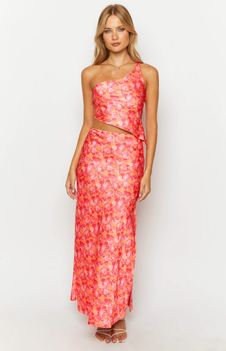 Front view of an orange and pink floral satin maxi skirt with a fitted silhouette and a subtle side slit