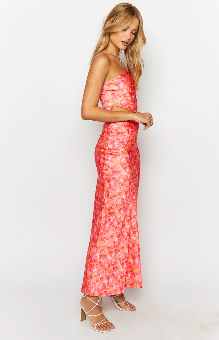Side view of an orange and pink floral satin maxi skirt, showing its flowing silhouette