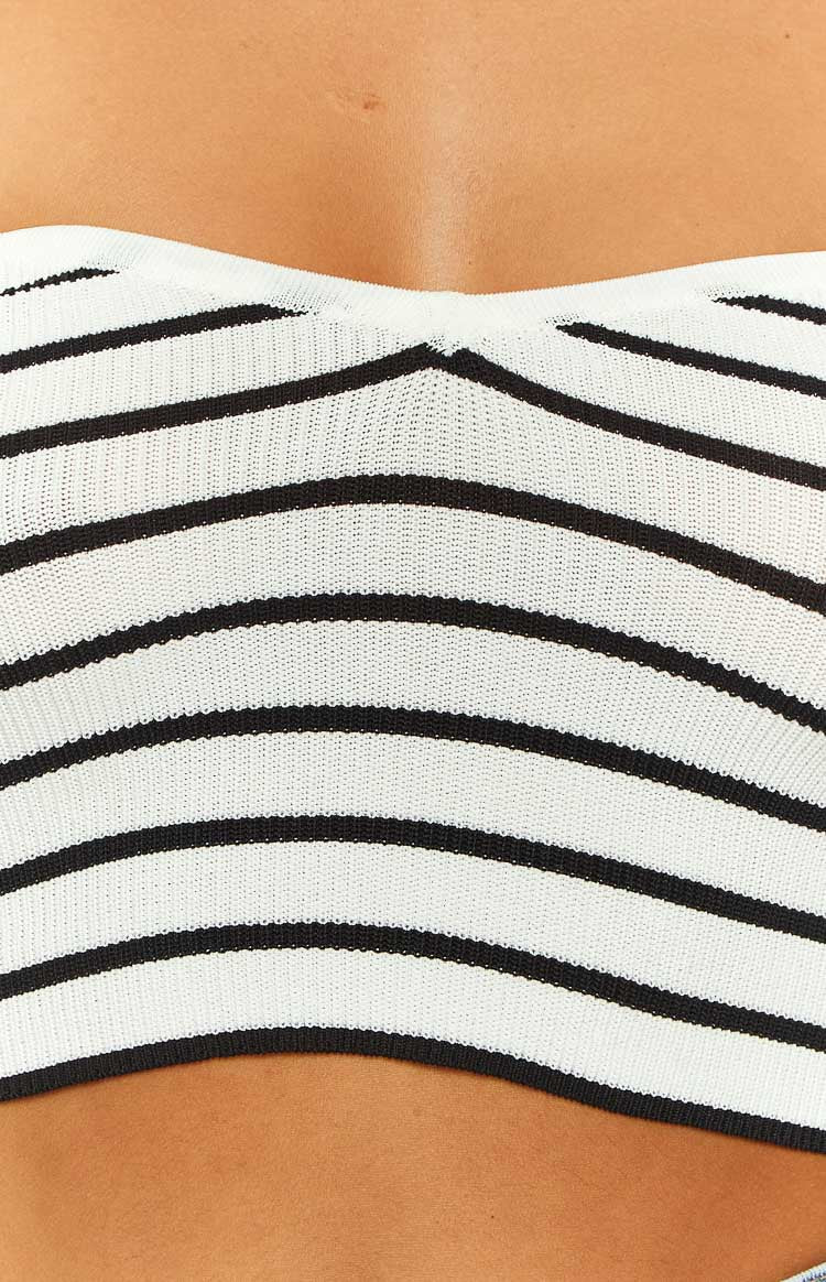 Close-up showing the fine knit texture of the black and white striped corset top with a V-neckline