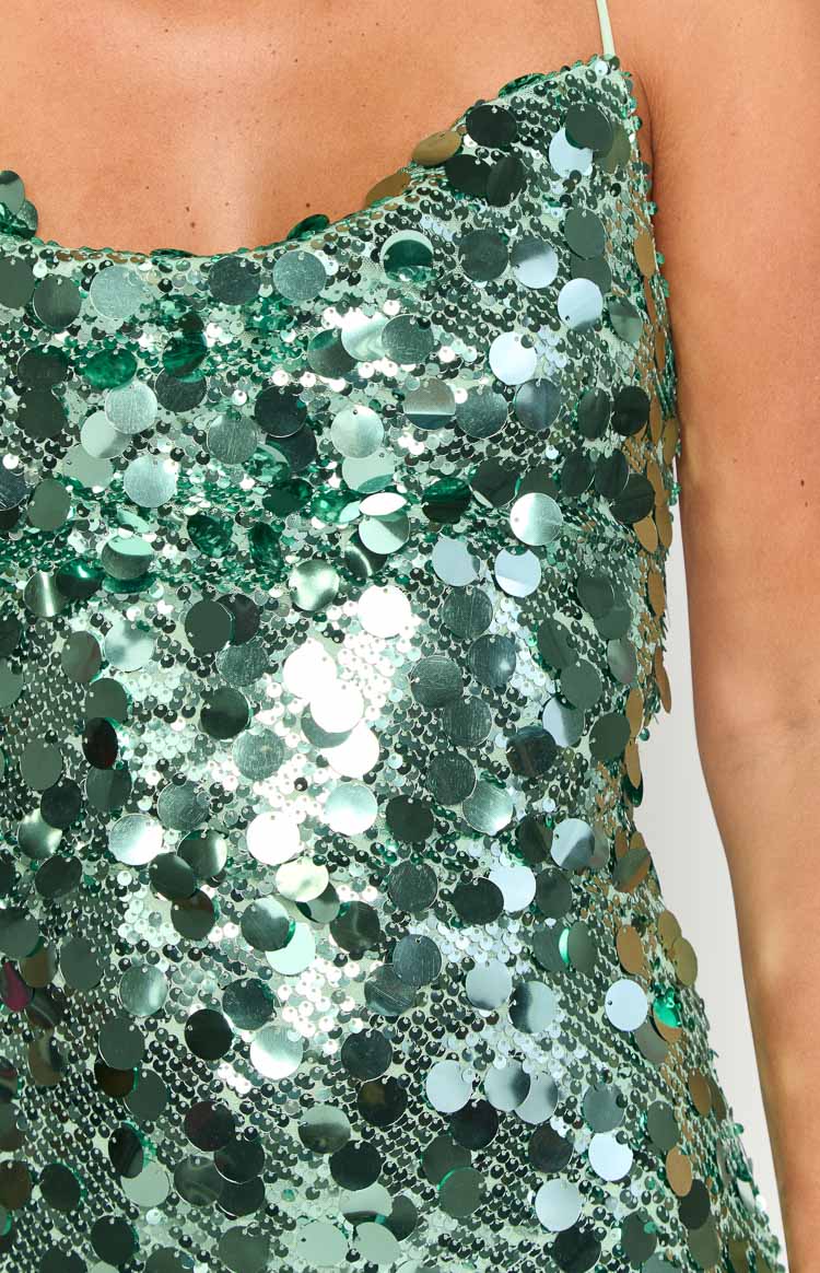 Detail shot of the aqua sequin mini dress fabric, showing a dense pattern of small and large round sequins
