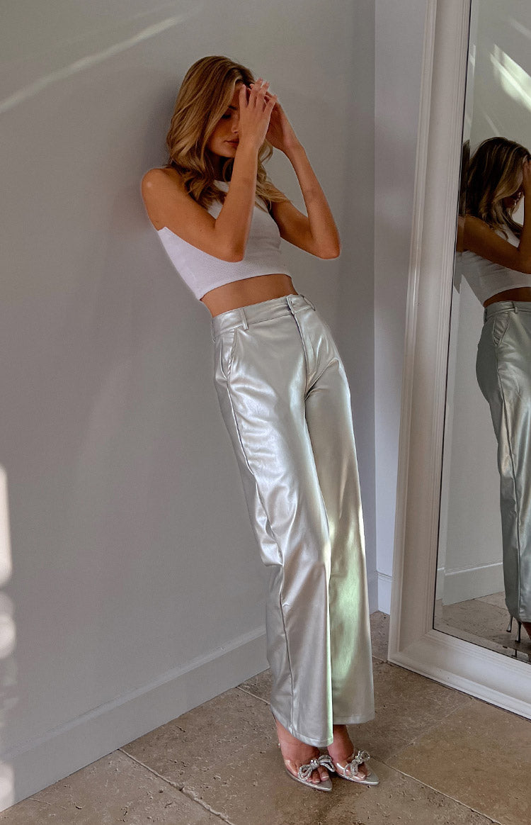 Side view of silver metallic wide-leg pants with a high waist and a relaxed, flowing silhouette