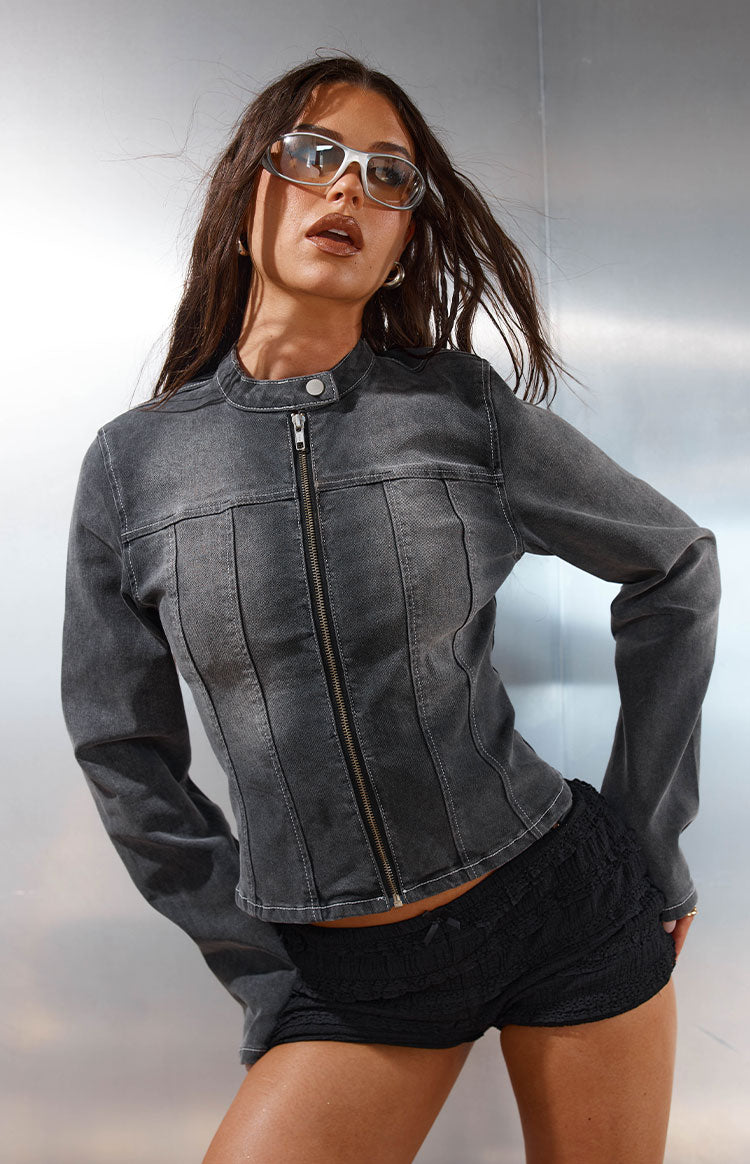 Front view of a black washed denim biker jacket with a round collar, full zipper, and vertical seam details