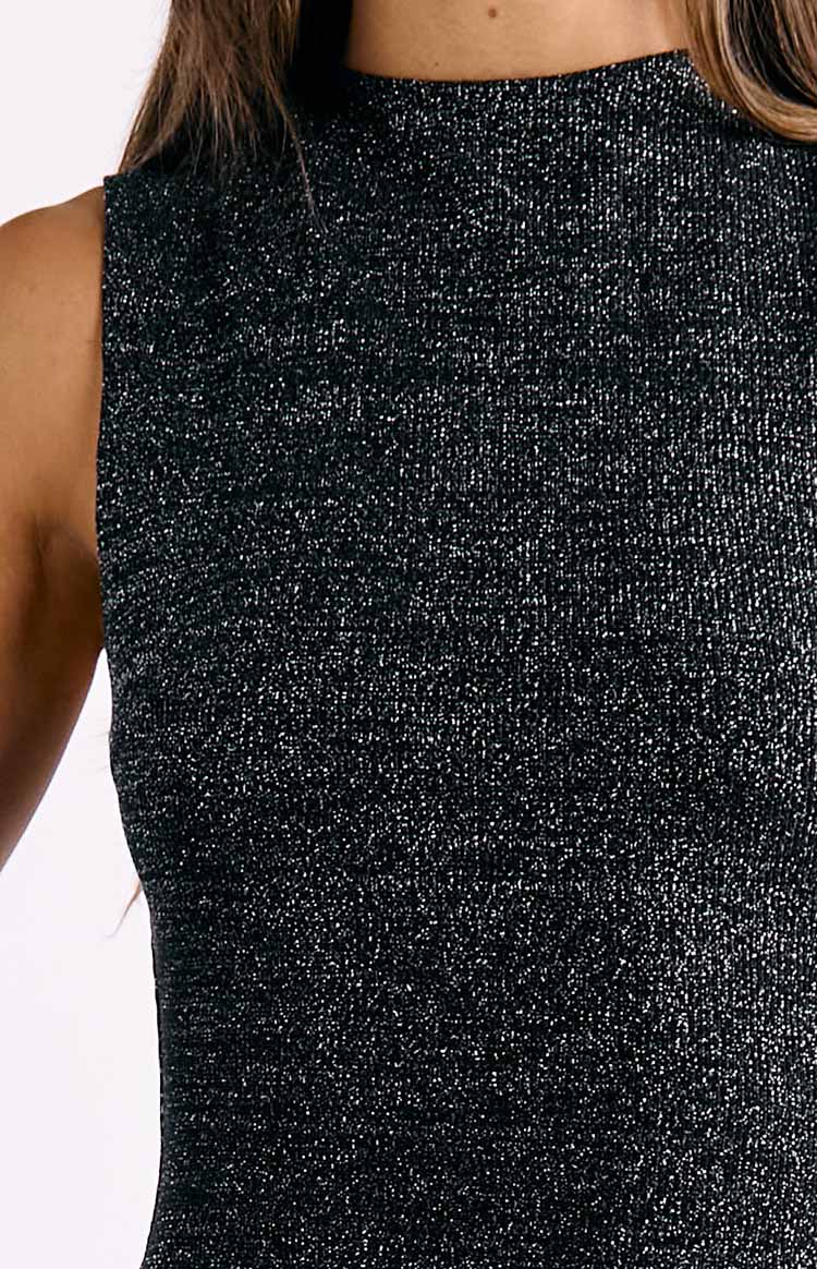 Close-up of the black sequin knit fabric with a high mock neck