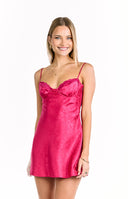 A vibrant pink mini-dress with a subtle floral jacquard pattern- thin spaghetti straps- and a scalloped lace trim on the sweetheart neckline. This dress is suitable for a party or a semi-formal gathering.