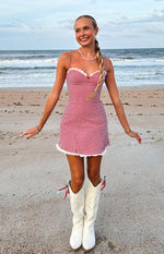 Front view of a red and white gingham mini dress with a white lace sweetheart neckline and ruffled hem