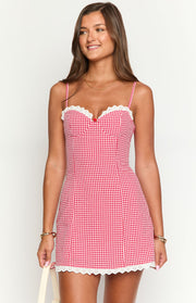 Red and white gingham mini dress with sweetheart neckline, white lace trim, red bow, and lace hem