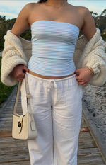 Front view of a fitted blue and white horizontal striped knit tube top