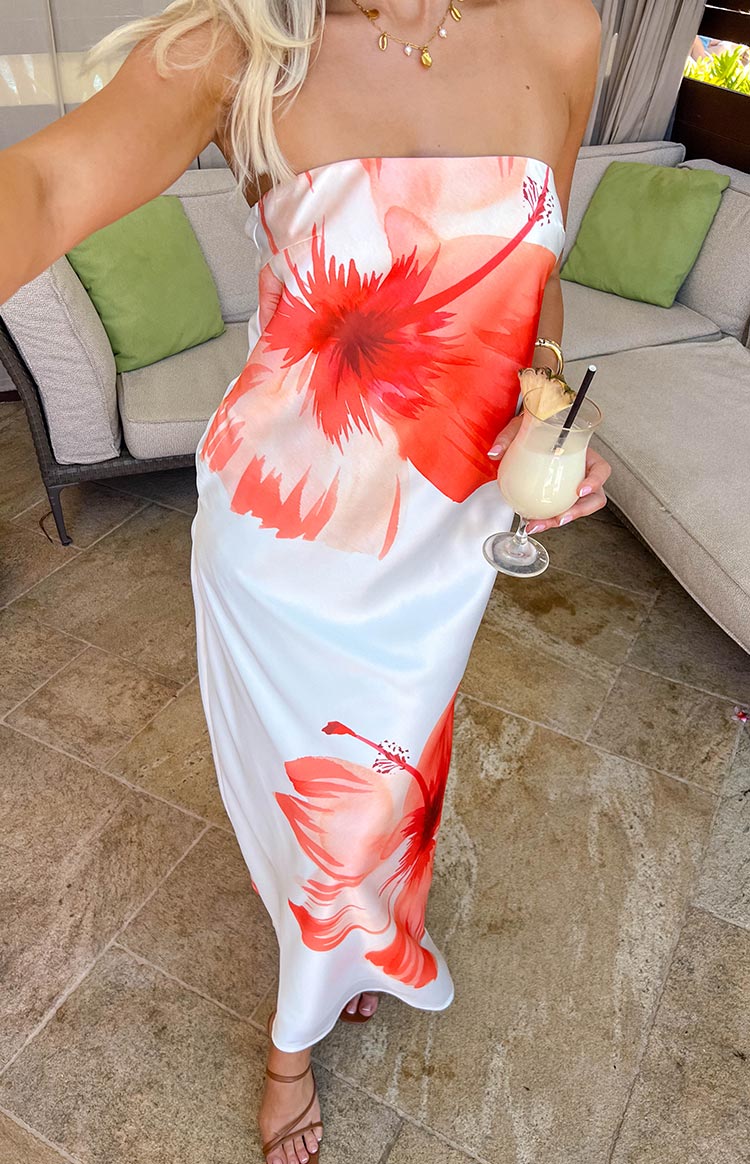 Full view of the white strapless maxi dress featuring large red and orange hibiscus floral print
