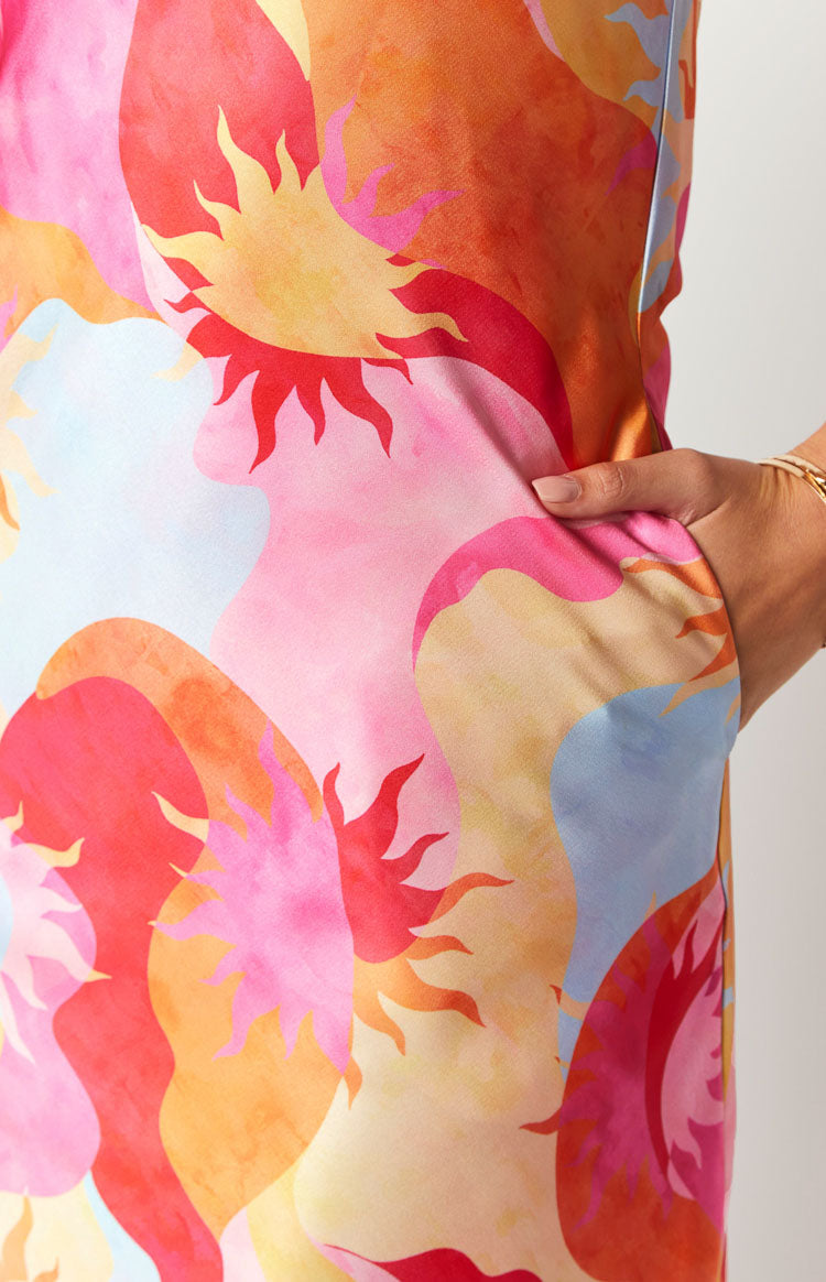 Close-up of a side pocket on the multi-coloured sun print maxi dress