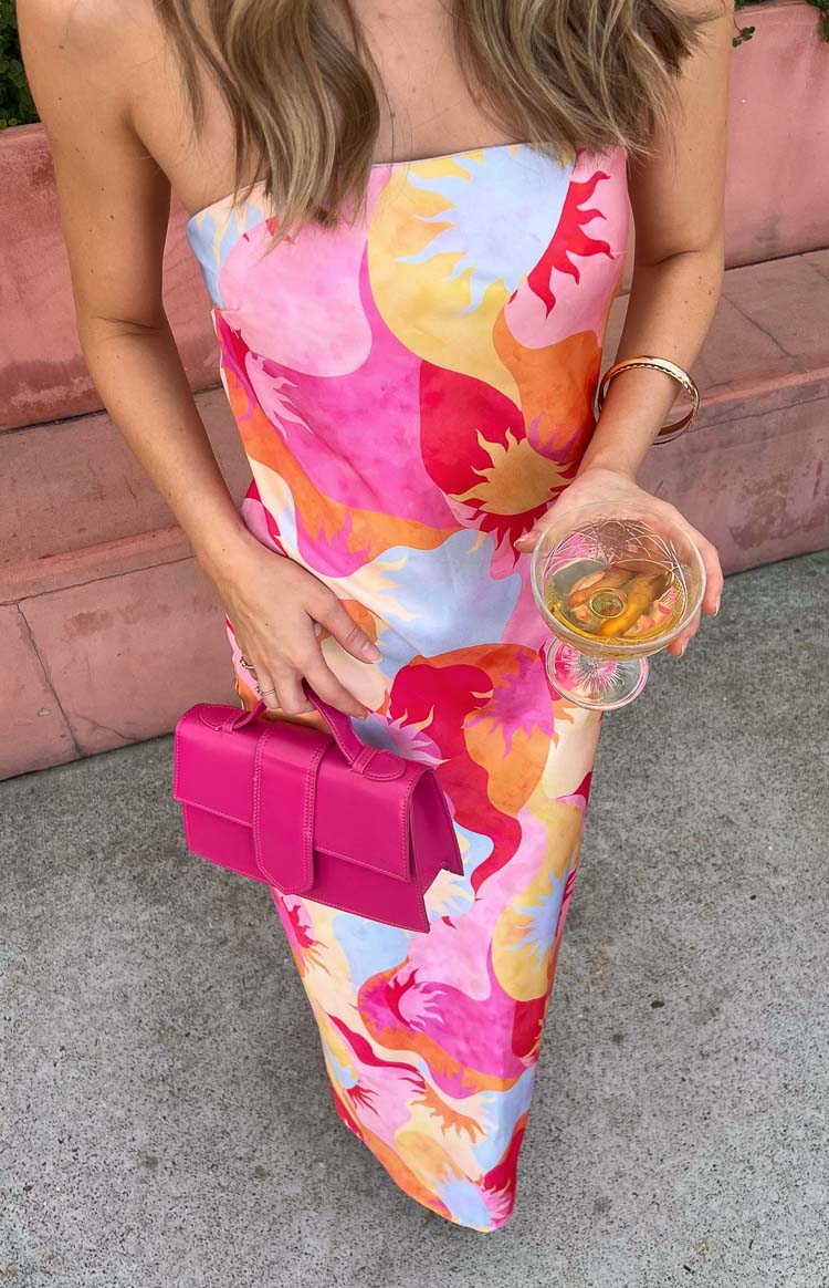 Close-up of the vibrant sun print strapless maxi dress with pink red orange yellow and blue motifs