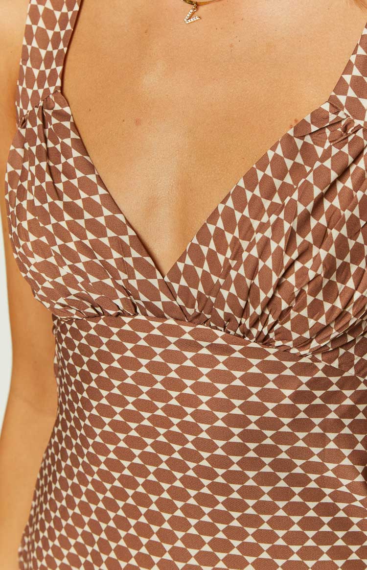 Close-up of the chocolate and white geometric print chiffon mini dress with a ruched V-neck bust