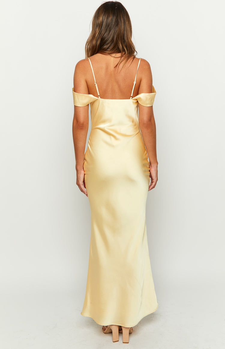 Rear view of a yellow satin maxi dress with thin spaghetti straps and off-shoulder draped sleeves