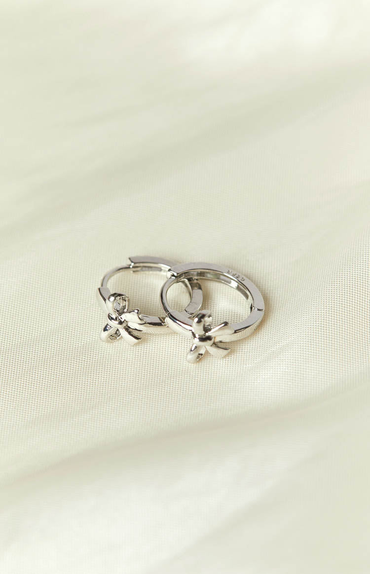 Darling Silver Bow Huggie Earrings (FREE over $100) Image