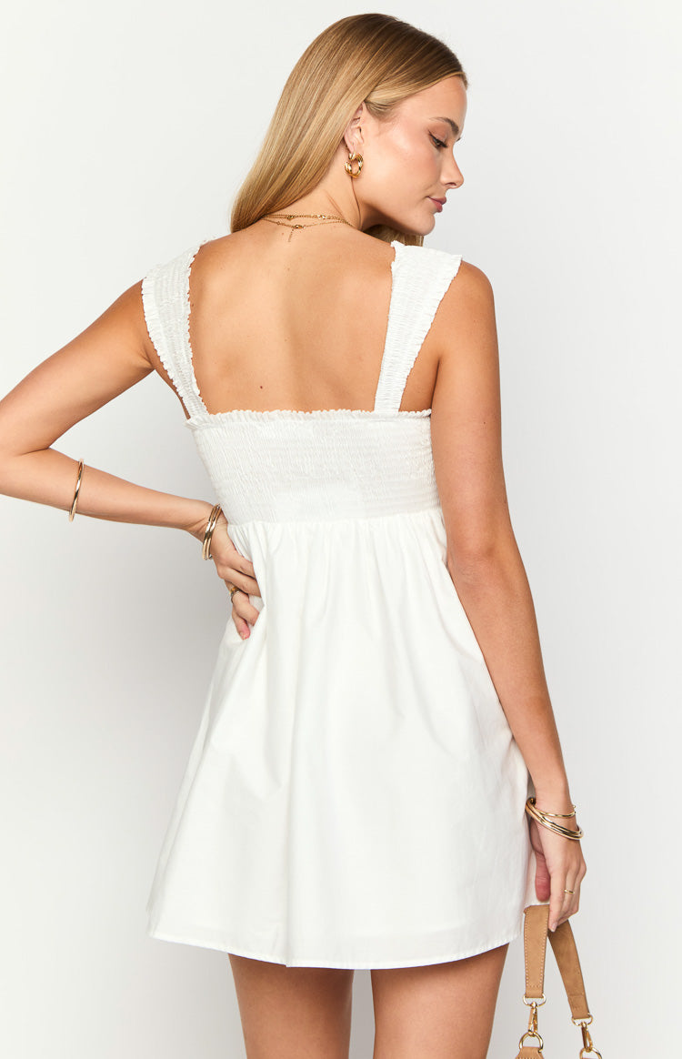 Rear view of a white mini dress with a shirred back bodice and wide shirred cap sleeves