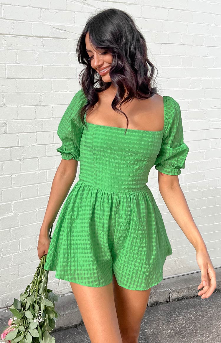 Bright green textured check playsuit with a square neckline, short puff sleeves, fitted bodice, and gathered waist