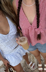 Light blue stripe button front top with a deep V-neckline and cropped fit