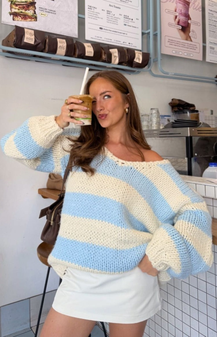 Off-shoulder light blue and cream striped chunky knit sweater with voluminous long sleeves