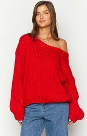 Red chunky knit sweater with a wide off-shoulder neckline, long balloon sleeves, and ribbed hem