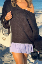 Black chunky knit sweater with an off-shoulder neckline, showing the prominent knit texture