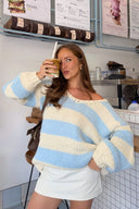 Light blue and white striped chunky knit sweater with a wide off-shoulder neckline and oversized sleeves