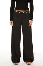 Black straight leg pants with a high waist and silver eyelet details, full length with a subtle textured fabric