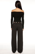Rear view of black straight leg pants with silver eyelet detail around the waist