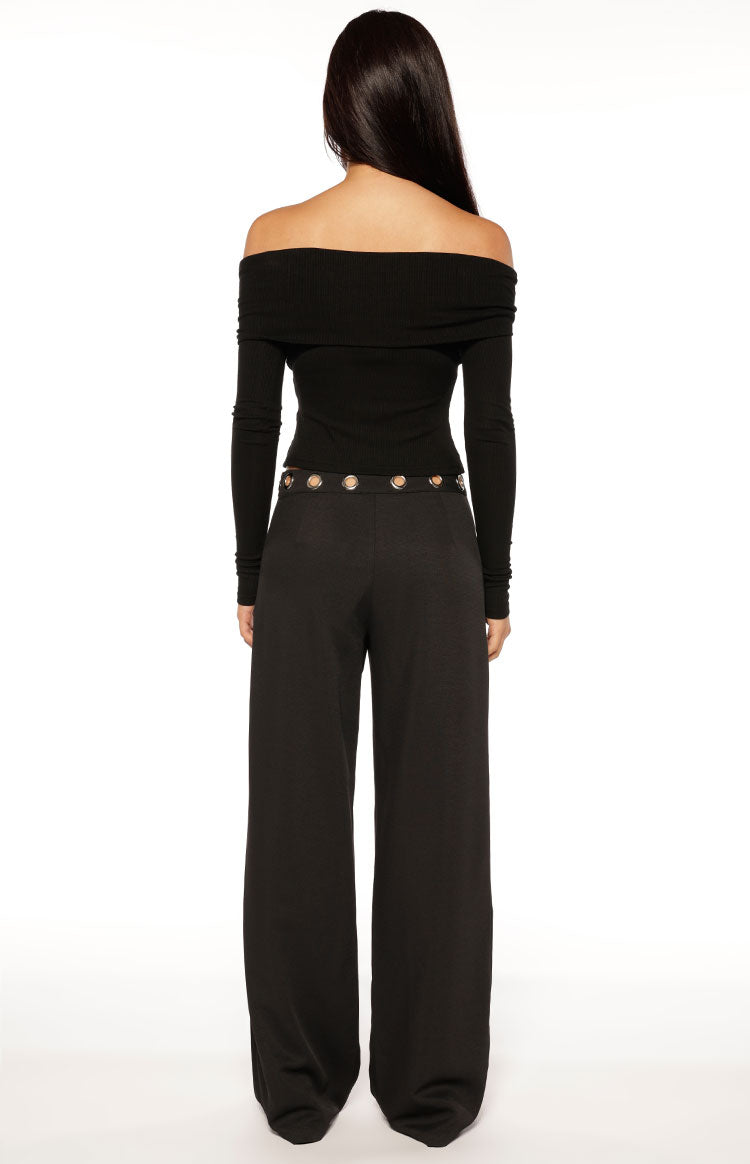 Rear view of black straight leg pants with silver eyelet detail around the waist