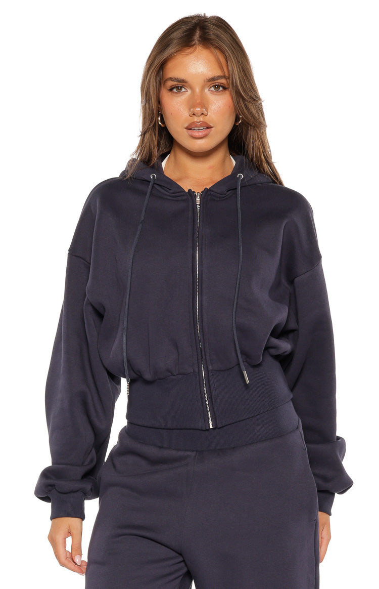 Cropped navy zip hoodie sweater with a drawstring hood, silver front zip, and wide ribbed hem