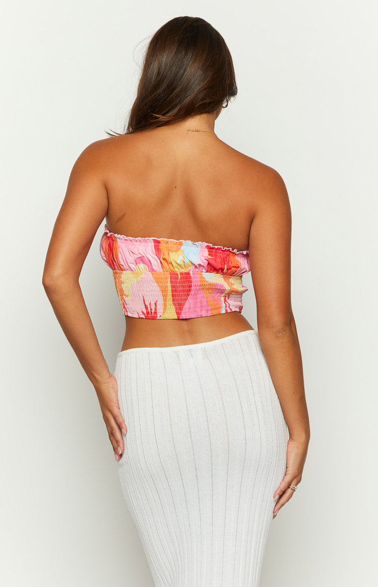 Rear view of the pink sun print strapless crop top with a wide shirred elastic back