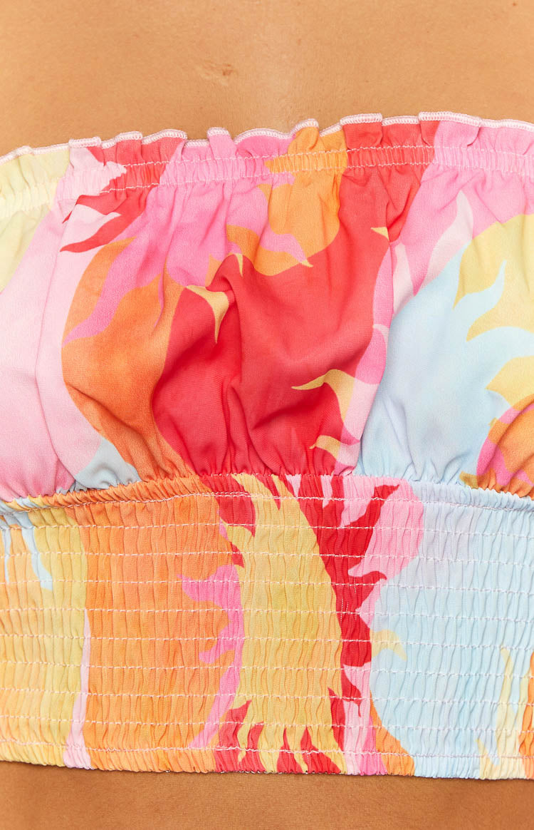 Close-up of the colourful sun print fabric with shirred top edge and hem of the crop top