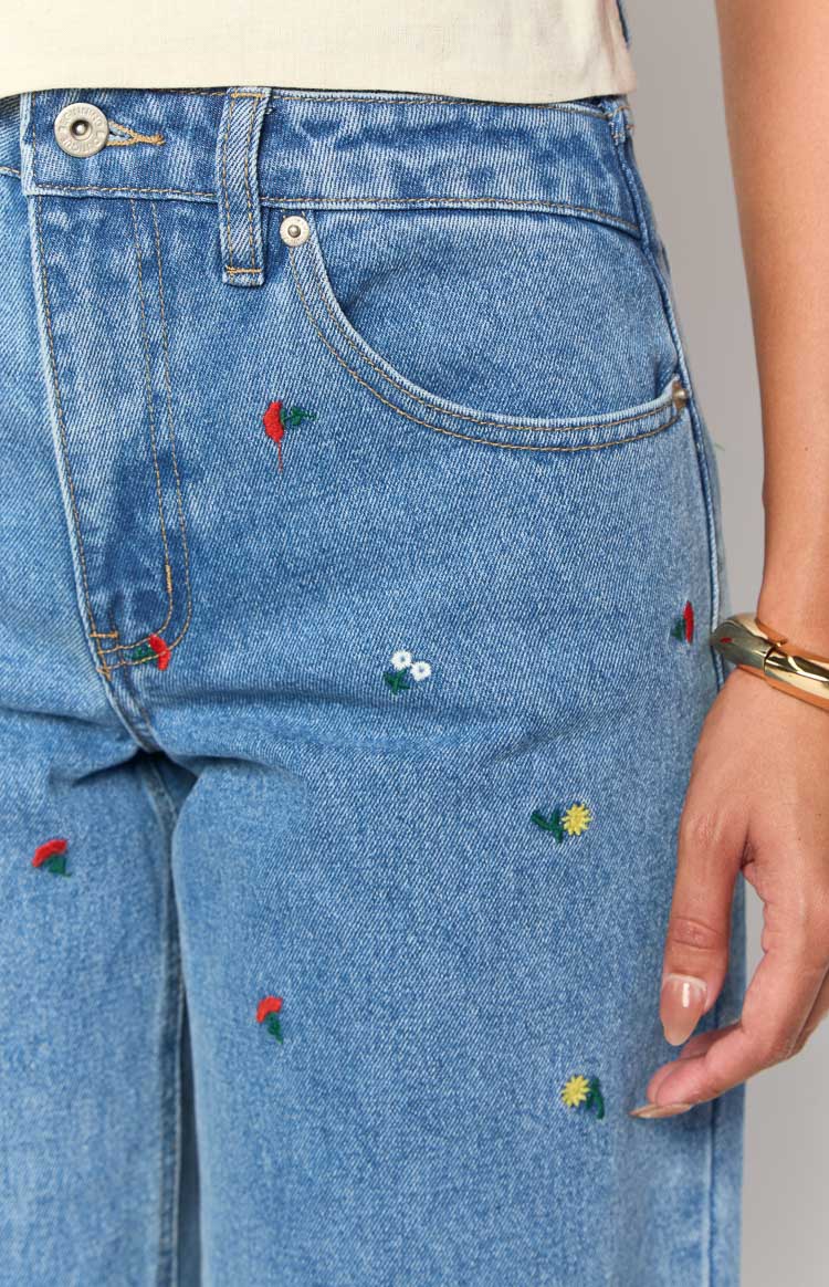 Beginning Boutique Kansis Blue Embroidered Uneven Waist Jeans light blue denim with colourful floral embroidery and high waist
