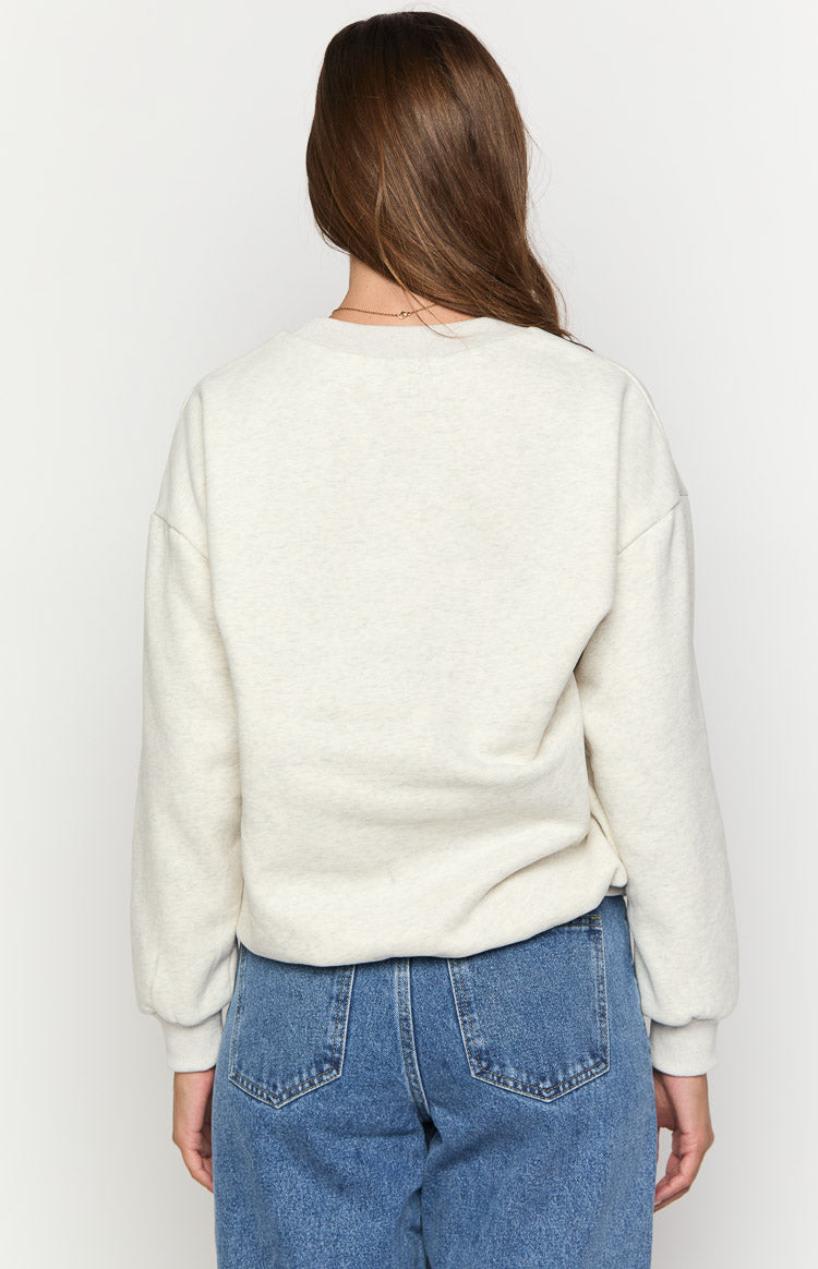 Rear view of an oat marle crew neck sweater with long sleeves and a relaxed fit