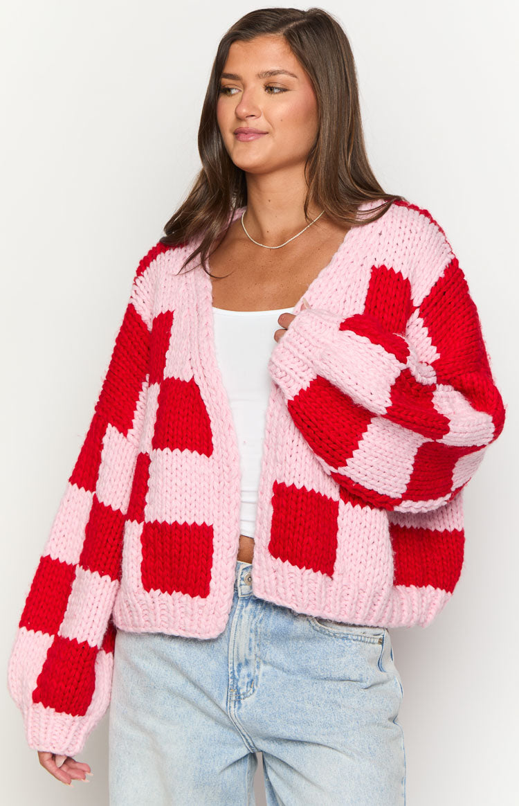 Pink and red checkered chunky knit cardigan with an open front and balloon sleeves