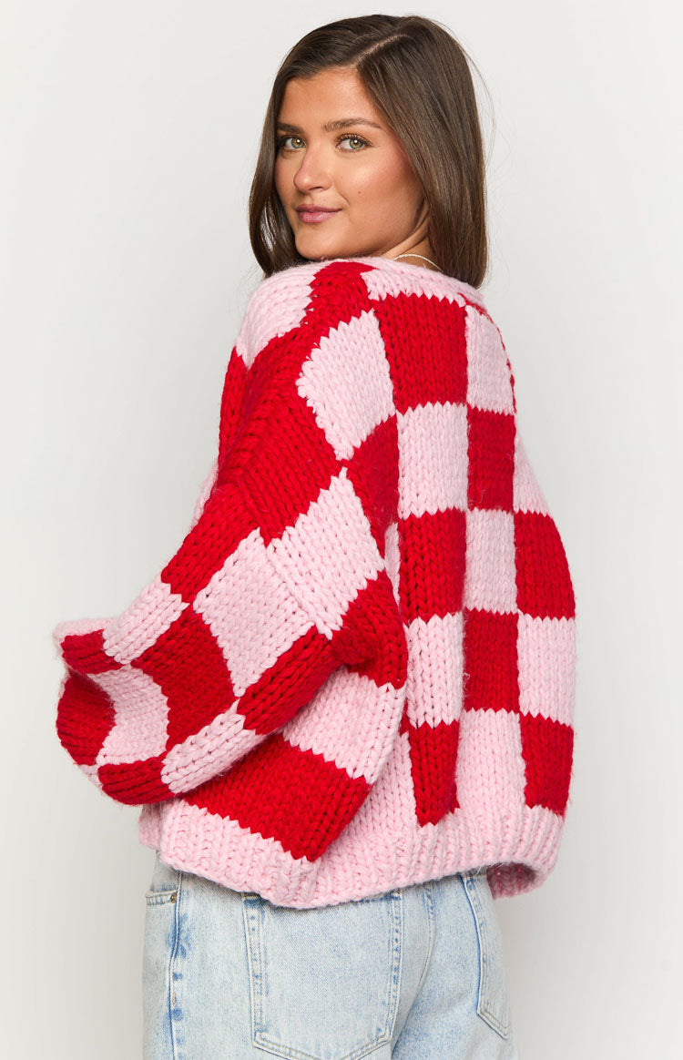 Oversized pink and red checkered chunky knit cardigan with prominent balloon sleeves