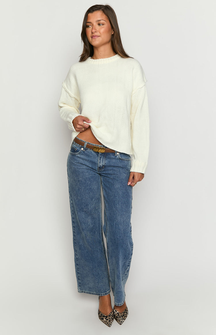 Cream knit sweater showing the raw edge hem and slightly cropped length