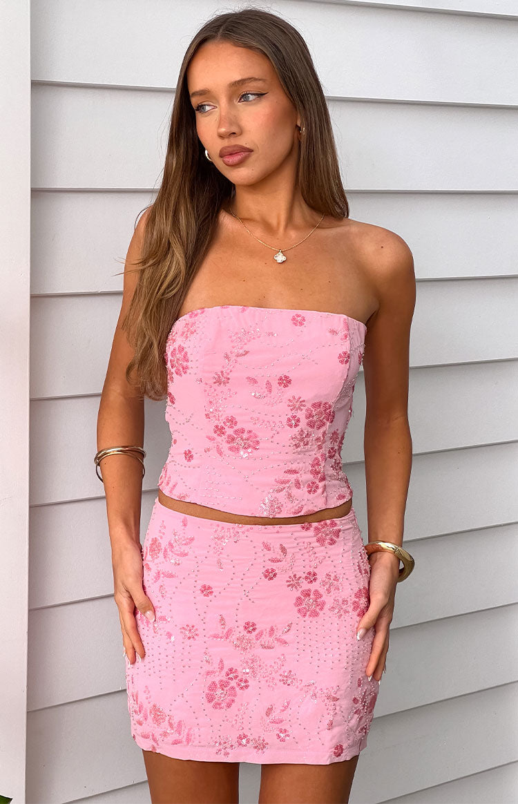 Front view of the light pink mini skirt with a fitted silhouette and all-over floral beading and sequins