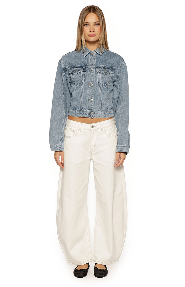 Front view of a mid-wash blue denim jacket with a collar, button front, chest pockets, and cropped cinched waist