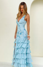 Side view of a light blue sequin maxi dress showing the V-neck, floral embroidery, high leg slit, and tiered ruffle hem