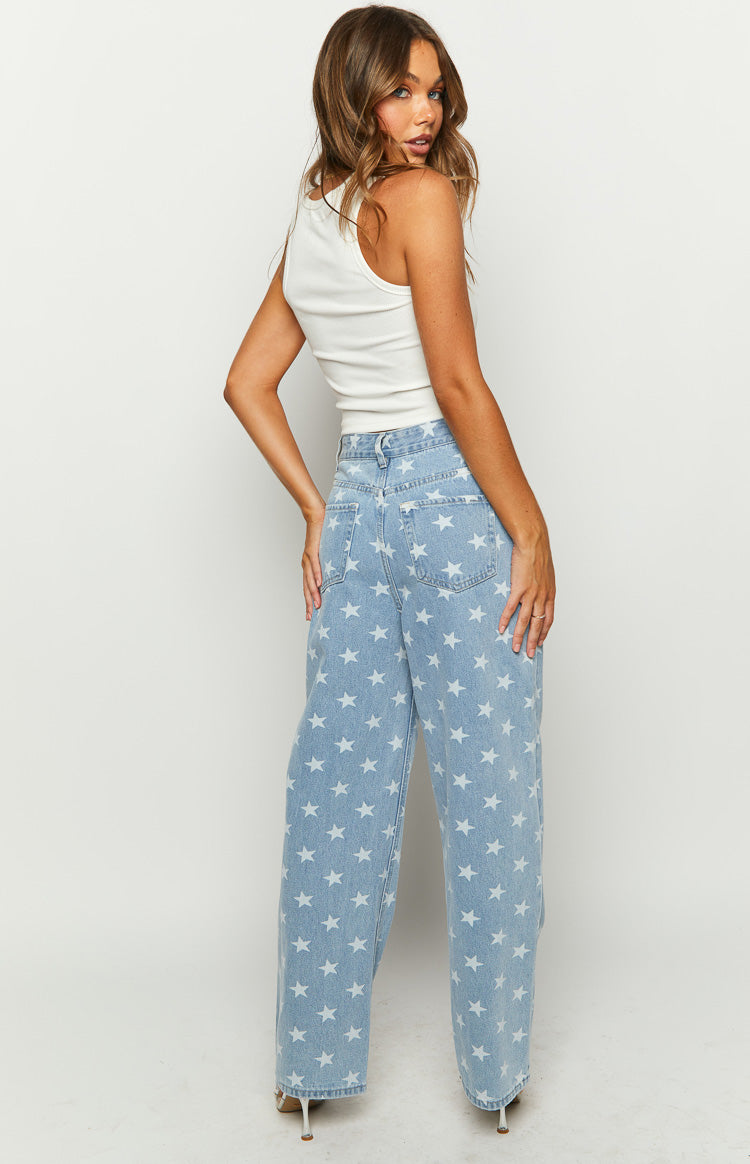 Rear view of light blue wide-leg denim jeans with all-over white star print