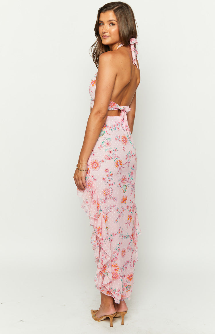 Side view of a pink floral maxi skirt with a ruffled asymmetrical hem
