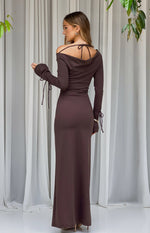 Rear view of a chocolate jersey maxi dress with a cowl back, tie-up spaghetti straps, and long sleeves with tie cuffs
