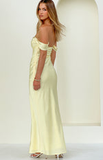 Side view of a light yellow off-shoulder maxi dress with a sweetheart neckline and ruched detail at the waist