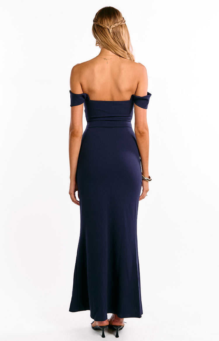 Rear view of a navy off-shoulder crepe maxi dress with a fitted bodice and flowing skirt