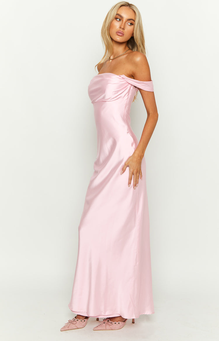 Side view of a light pink off-shoulder maxi dress with a draped neckline and flowing satin skirt