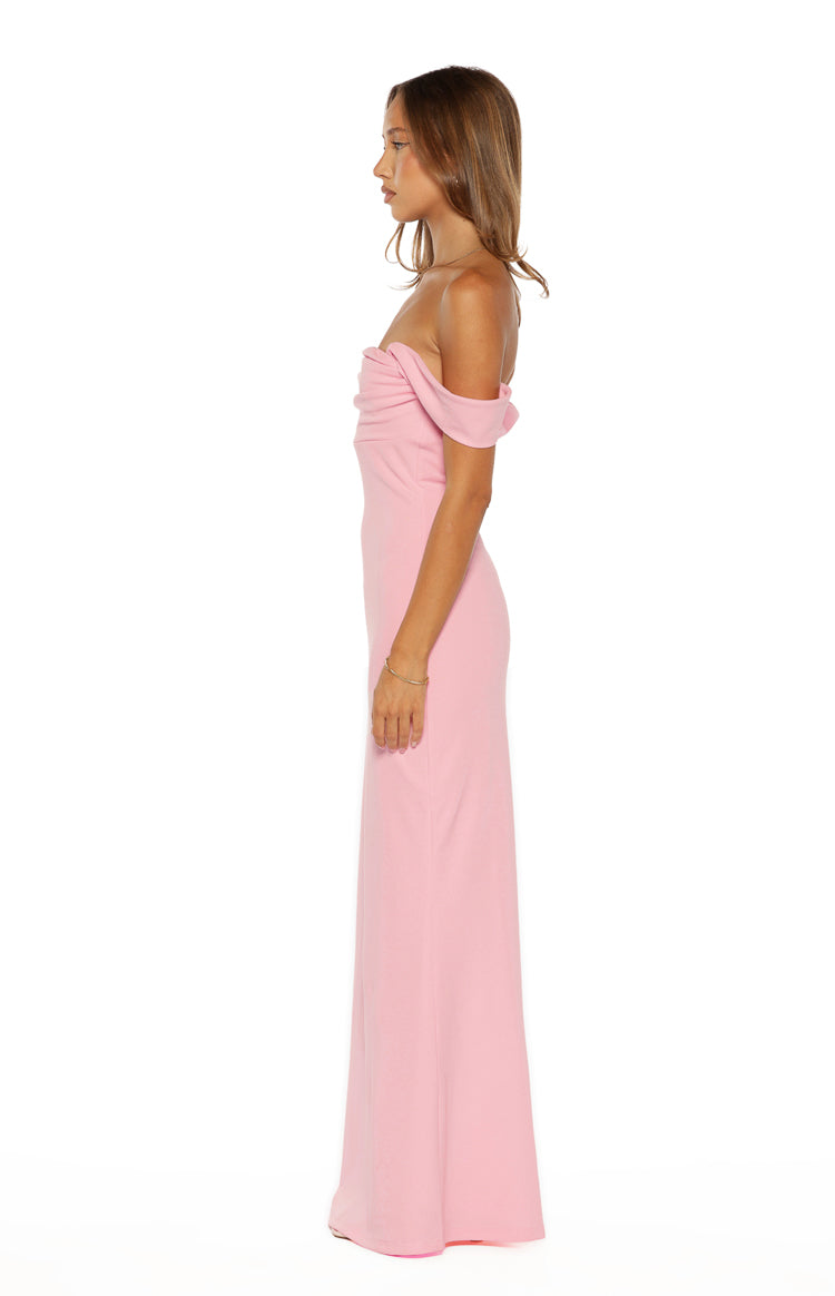 Side view of the pink crepe off-shoulder maxi dress with a draped bust and fitted silhouette